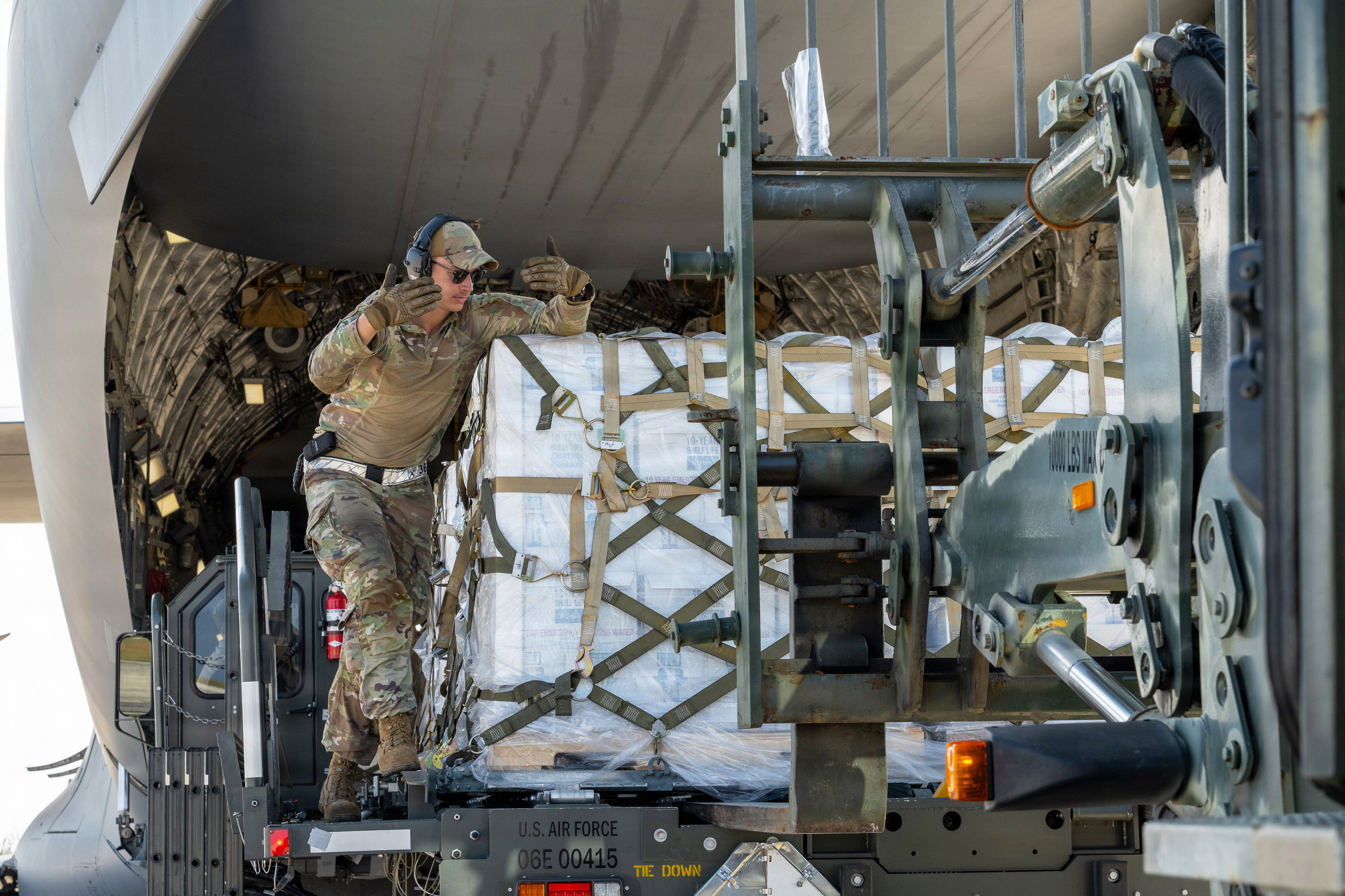 USAF airman loading cargo for strategic airlift mission