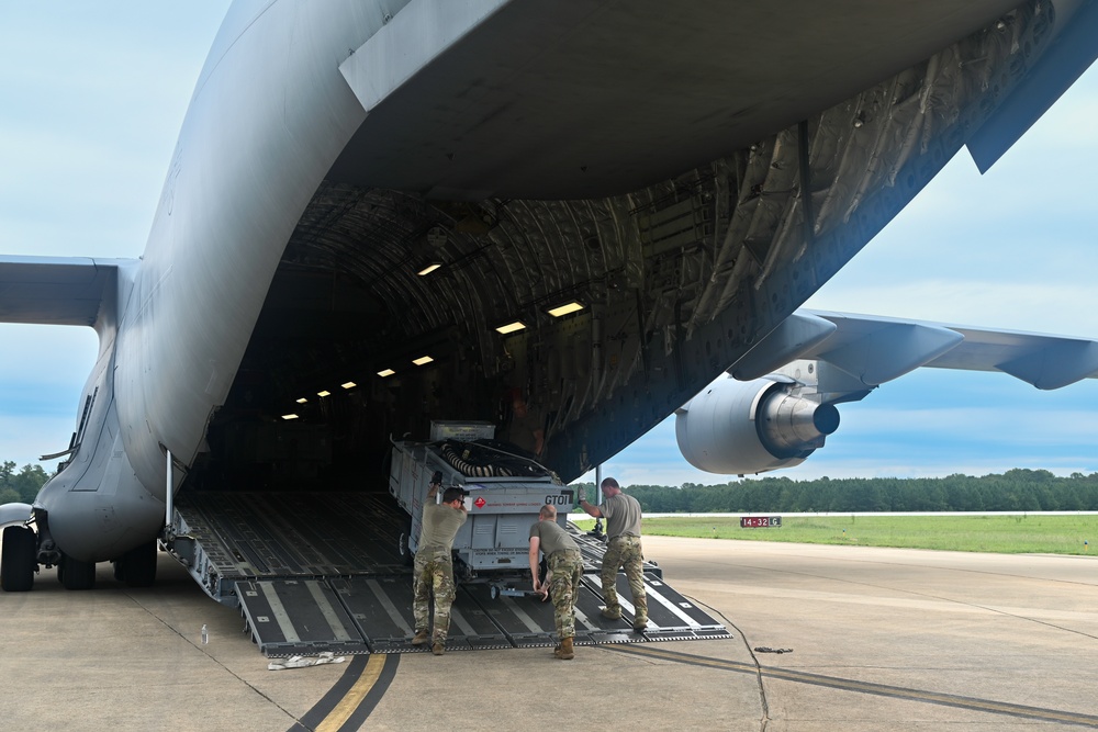 Airmen loading industrial cargo for federal supply operations
