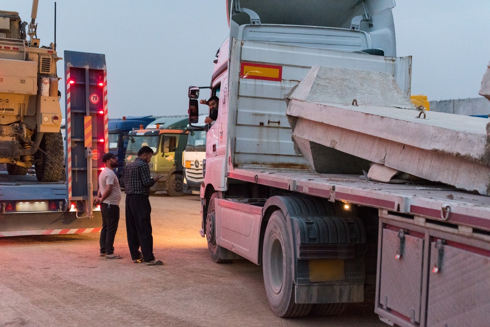 Coalition military supply convoy staging for theater-scale commodity procurement
